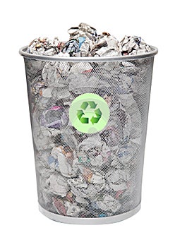 Recycling bin full of crumpled papers over white background