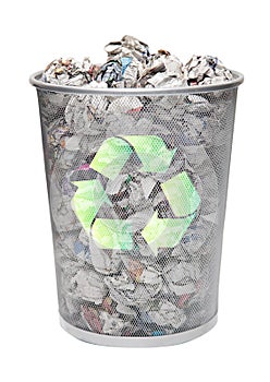 Recycling bin full of crumpled papers over white background