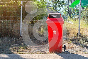 Recycling bin stands out door,