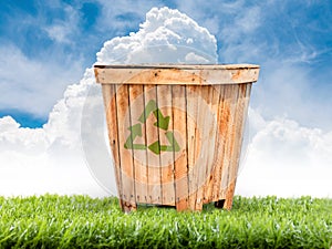 Recycling bins made of wood on the lawn