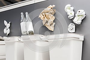 Recycling bins with paper, plastic, glass, metal, organic and electronic waste on grey background.Recycling of household