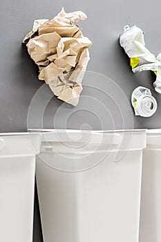 Recycling bins with paper, plastic, glass, metal, organic and electronic waste on grey background.Recycling of household