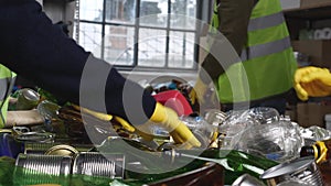 Recycling Center. Glass, cans and plastic bottles are inspected, sorted, baled and trucked to mills and plants where the