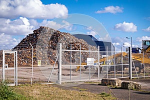 Recycling centre from behind a fence.