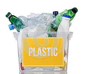 Recycling concept. Container with plastic bottles and plastic inscription on yellow isolated