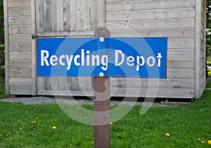 Recycling depot sign in front of a structure
