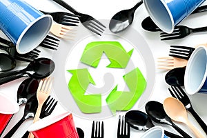 Recycling and eco concept with plastic cups, spoons and forks frame on white background top view