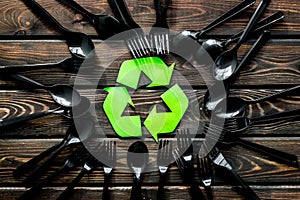 Recycling and eco concept with plastic spoons and forks frame on wooden background top view