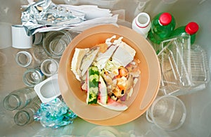 Recycling and ecology. Sorting segregating household waste paper, glass, plastic into contaner captured from above, flat lay.