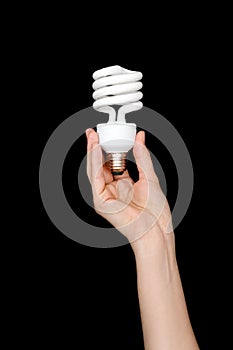 Recycling, electricity, environment and ecology concept - close up of hand holding energy saving lightbulb or lamp. Compact fluore