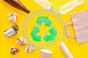 Recycling. Green recycle eco symbol. Recycled arrows sign near matherials for recycle and reuse on yellow background top