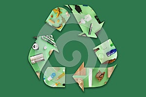 Recycling icon mocked up of different types of waste materials on green background. photo