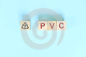 Recycling icon number 3 for PVC or polyvinyl chloride symbol on wooden blocks