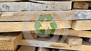 Recycling icon pattern isolated on waste wood from a construction site background, creative environmental protection symbol