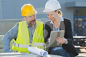 recycling industry workers using tablet outside factory