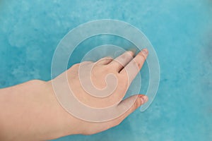 Recycling material of papers. Paper in blue water. Woman hand with recycling paper in water. Selective and soft focus