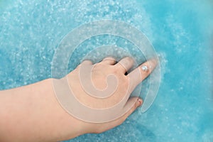 Recycling material of papers. Paper in blue water. Woman hand with recycling paper in water. Selective and soft focus