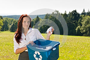 Recycling paper box businesswoman in sunny meadow