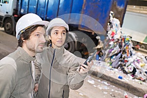 recycling plant workers talking in walkie-talkie