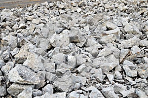 Recycling and reuse crushed concrete rubble, asphalt, building material, blocks. Broken concrete slabs at construction site.