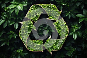 Recycling sign made of grass on leaves background. Environmental protection, ecology, recycling concept