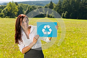 Recycling sign - Young businesswoman sunny meadow