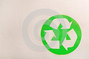 Recycling symbol on cardboard paper, top view