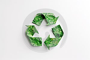 Recycling symbol made of crumpled green paper.