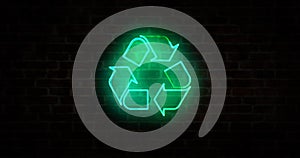 Recycling symbol neon on brick wall