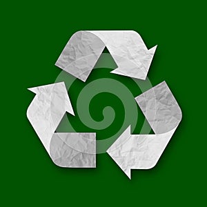 Recycling Symbol - three folded from Recycle Paper arrows that form a triangle isolated on dark green background