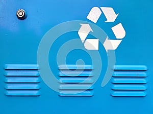 Recycling symbol on vivid blue background with vents and lock.