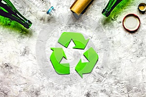 Recycling symbol with waste on gray background top view mock up