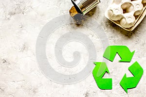 Recycling symbol with waste on gray background top view mock up