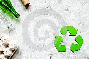 recycling symbol with waste on gray background top view mock up