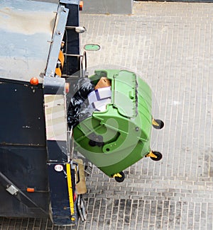 Recycling truck picking up bin