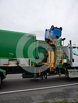 Recycling truck picking up bin