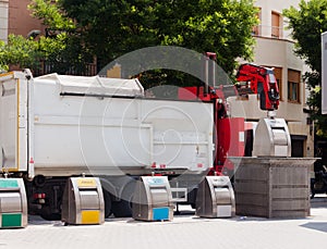 Recycling truck picking up bin at city