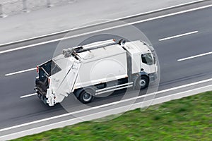 Recycling truck rides on the road in the city