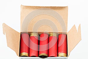 Red 12 gauge shotgun shells loaded into a cardboard box