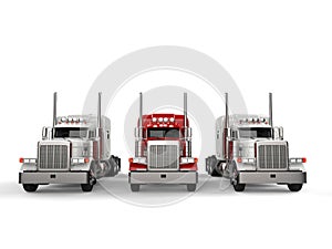Red 18 wheeler truck in between two white trucks