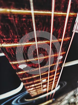 Red acoustic guitar close up in dark background