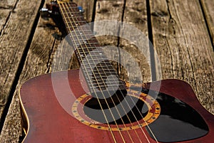 Beat up red acoustic guitar photo