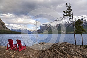 Red Adirondack Chairs at Lake Minnewanka in Banff National Park