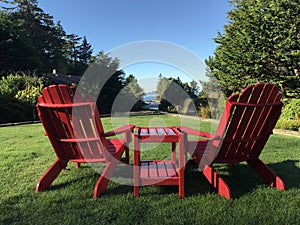 Red Adirondack chairs to enjoy the view at Tofino, BC