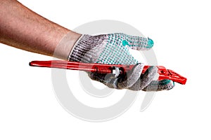 Red adjustable pipe wrench with in hand in knitted protective household glove on white background