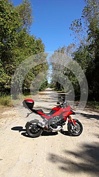 Red Adventure Motorcycle on Dirt Road