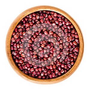 Red adzuki beans in wooden bowl over white