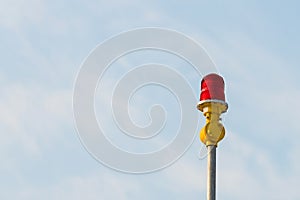 Red aircraft warning lights with blue sky background