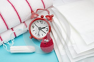 Red alarm clock, dreamy smile crochet blood drop, daily menstrual pad and tampon and terry towel. Menstruation sanitary woman hygi