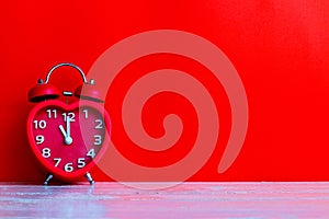 Red alarm clock mark at 11.00 o`clock